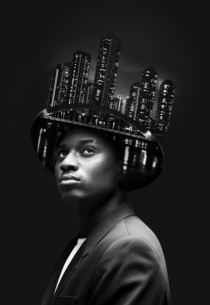 Portrait of a young Black professional in a suit, wearing a stylized city skyline as a crown — representing the ambition and future-facing mindset of AI Academy learners